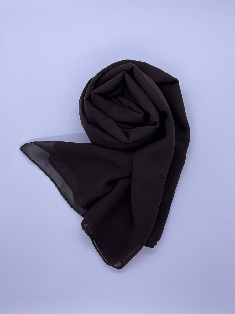 Dark brown Essential Chiffon Hijab with a semi-transparent design, secured with stylish pins, ideal for all-day comfort and versatile wear