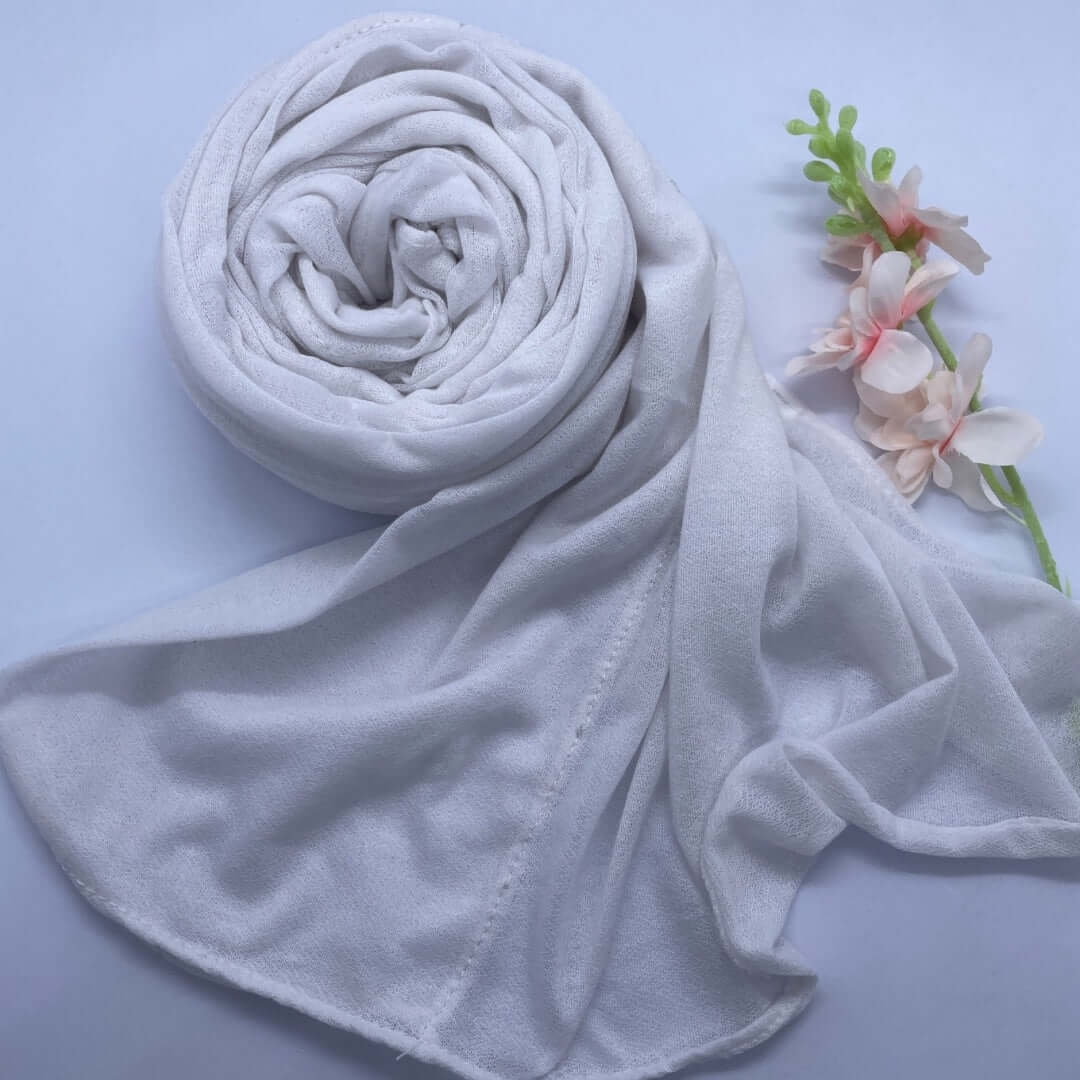 Close-up of a Kuwaiti hijab made from Turkish shash fabric in a folded pre-stitched front design, displayed in a soft, neutral color. The hijab appears lightweight, breathable, and non-slip, styled elegantly for everyday wear, work, or university use.