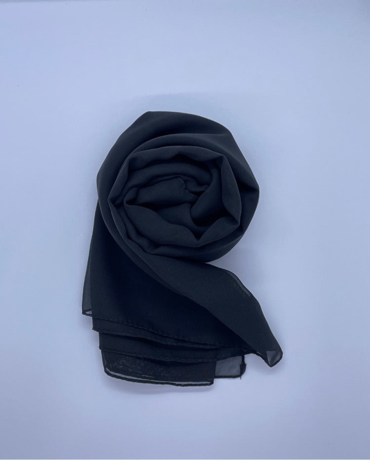 Black Essential Chiffon Hijab with a semi-transparent design, secured with stylish pins, ideal for all-day comfort and versatile wear