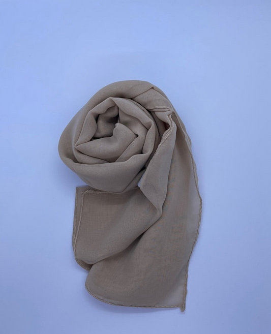 Sand Beige Essential Chiffon Hijab with a semi-transparent design, secured with stylish pins, ideal for all-day comfort and versatile wear