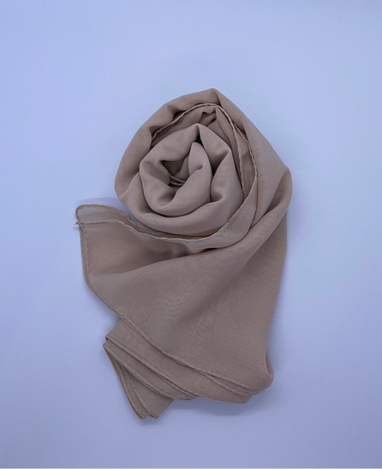 Beige Essential Chiffon Hijab with a semi-transparent design, secured with stylish pins, ideal for all-day comfort and versatile wear