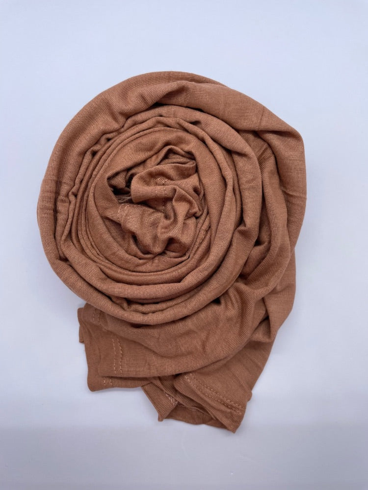 caramel brown Breathable cotton hijab with a matte sheen and textured finish, perfect for everyday wear and layering.