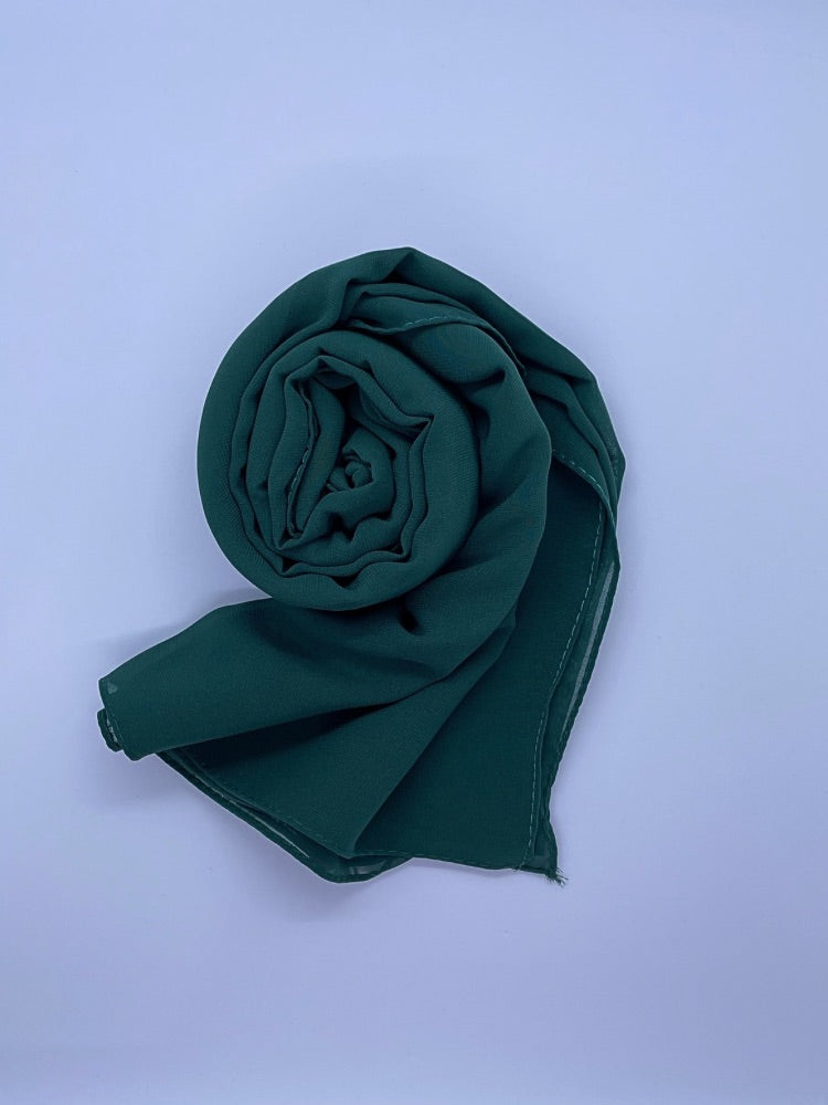 deep forest green Essential Chiffon Hijab with a semi-transparent design, secured with stylish pins, ideal for all-day comfort and versatile wear