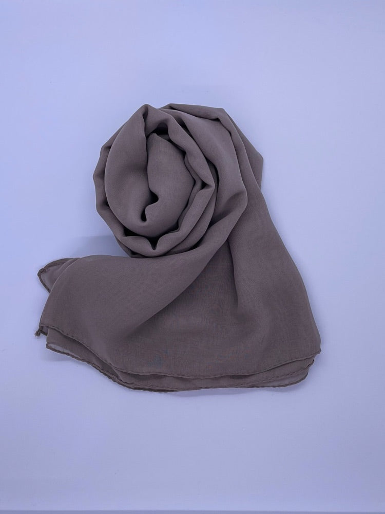 Grayish brown Essential Chiffon Hijab with a semi-transparent design, secured with stylish pins, ideal for all-day comfort and versatile wear