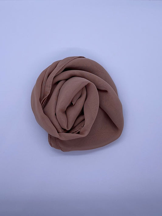 Soft mocha Essential Chiffon Hijab with a semi-transparent design, secured with stylish pins, ideal for all-day comfort and versatile wear