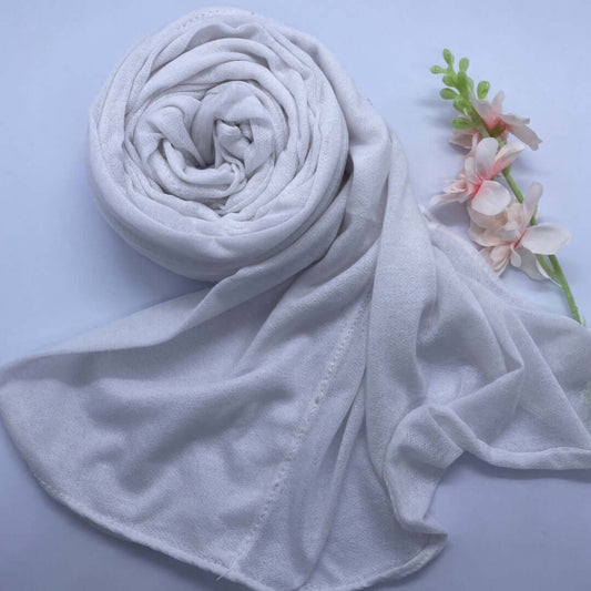 Close-up of a Kuwaiti hijab made from Turkish shash fabric in a folded pre-stitched front design, displayed in a soft, neutral color. The hijab appears lightweight, breathable, and non-slip, styled elegantly for everyday wear, work, or university use.