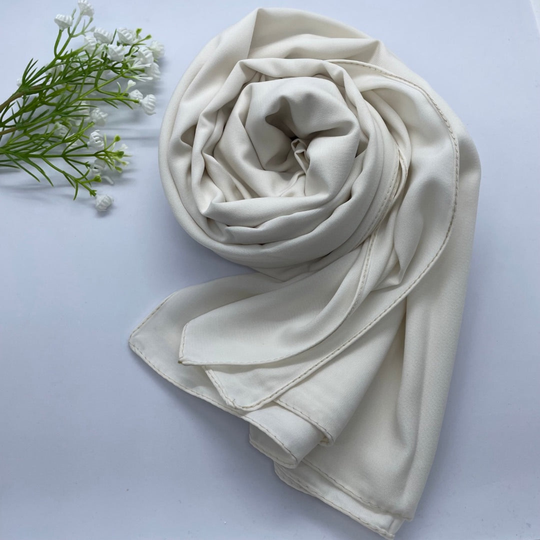 Premium Opaque Ivory Georgette Hijab with full coverage in a mid-weight, flowy fabric and matte finish. Breathable and non-slip, offering a soft drape and secure fit. Non-transparent for modesty and comfort, suitable for casual and formal wear.