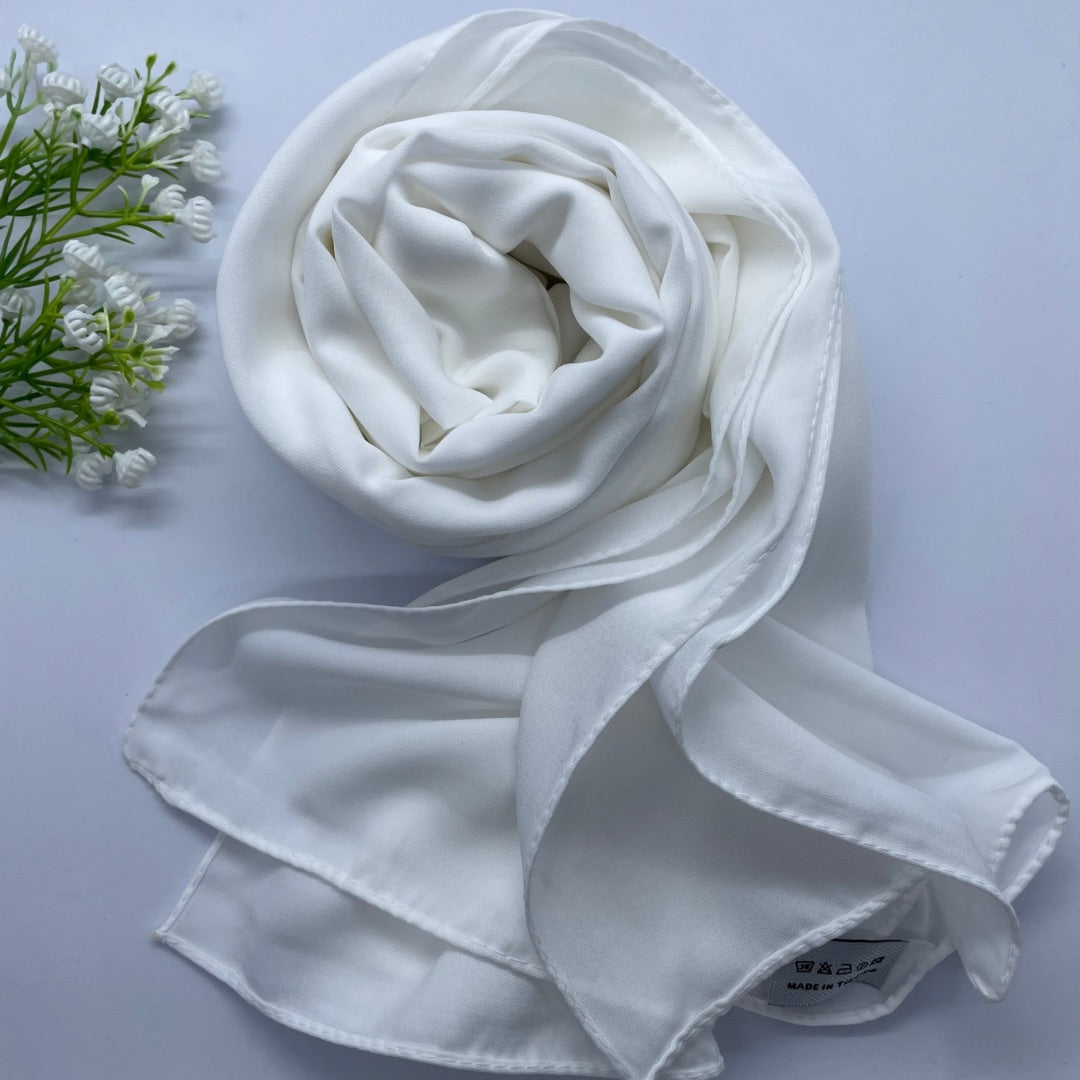 Premium Opaque off-white Georgette Hijab with full coverage in a mid-weight, flowy fabric and matte finish. Breathable and non-slip, offering a soft drape and secure fit. Non-transparent for modesty and comfort, suitable for casual and formal wear.