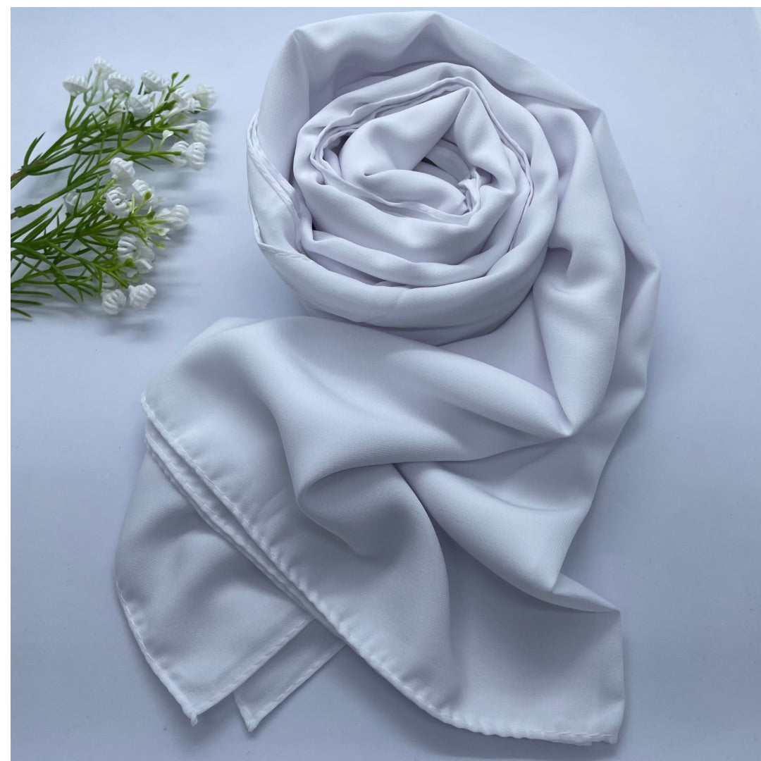 Premium Opaque bright white Georgette Hijab with full coverage in a mid-weight, flowy fabric and matte finish. Breathable and non-slip, offering a soft drape and secure fit. Non-transparent for modesty and comfort, suitable for casual and formal wear.